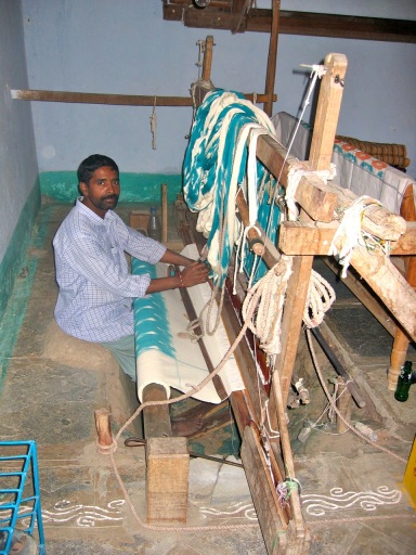 Hand loom weaver in a pit loom